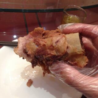 A thin plastic glove protects my hand from fatty pork-on-the-bone.
