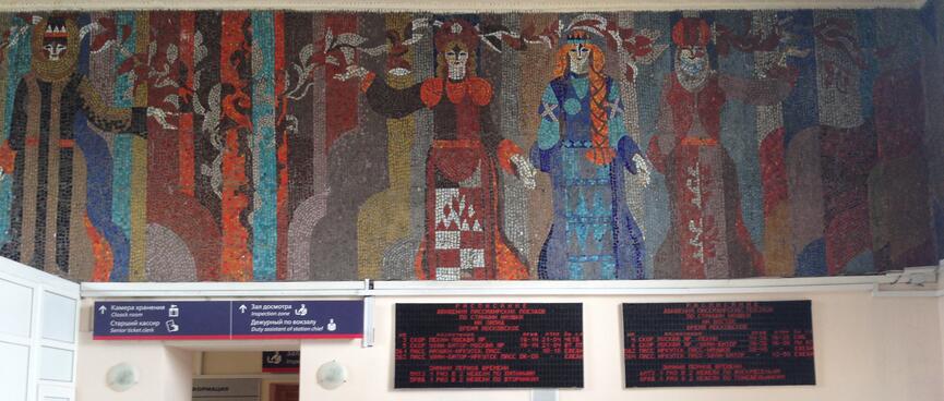 A colourful tiles mural depicts women in different outfits.