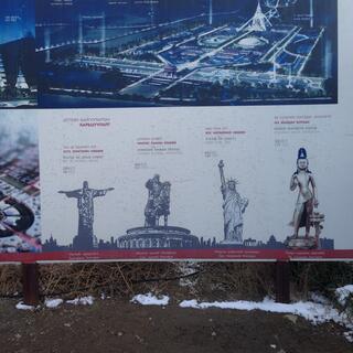A billboard compares famous statues around the world with one that is under construction here.