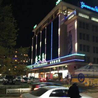 A multi-story building with neon trim.