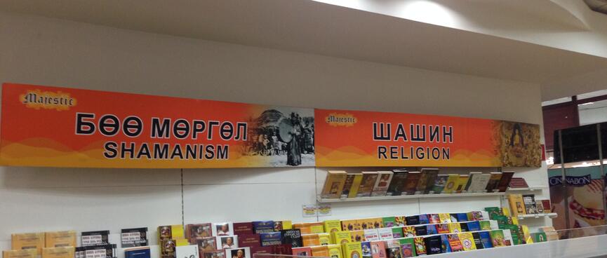 Two halves of a book shelf are signposted with ʼShamanismʼ and ʼReligionʼ.