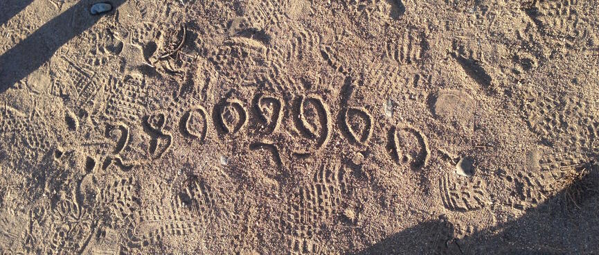 Numbers written in the sand.