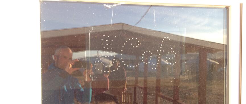 Our group is reflected in the window of the camp cafe.