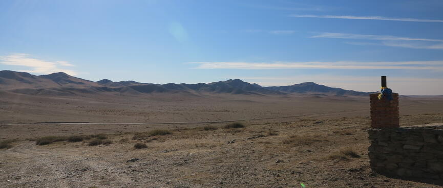 Barren steppes and distant hills.