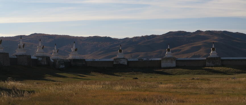 White stone monuments at equal intervals on the perimeter wall.