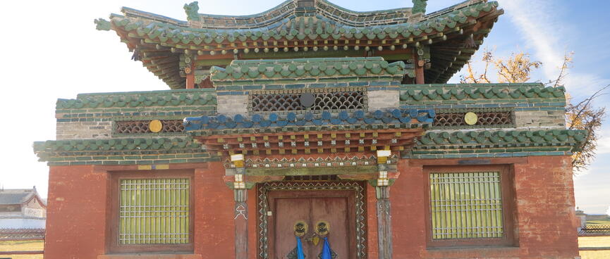 A red single story building with ornate smiling eaves.