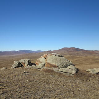A small pile of rocks complement the hilly horizon.