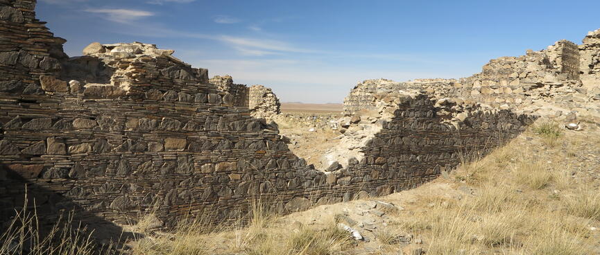 A v-shaped hole in a tall stone wall.