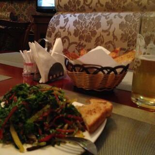 Salad, toast and beer in the paisley dining booth.