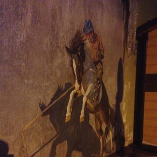 A mural of a man on a rearing horse.