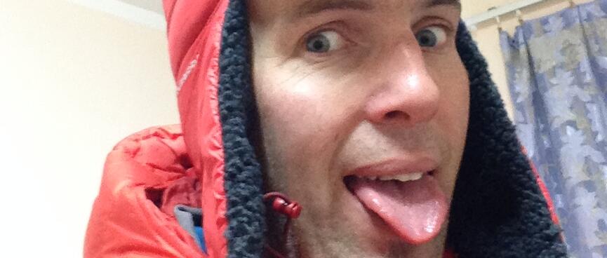Wearing a red hat with long ear flaps and sticking my tongue out like a dog.