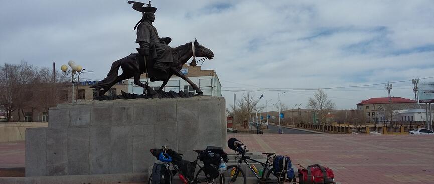 A statue of a rider on a horse above our bikes.