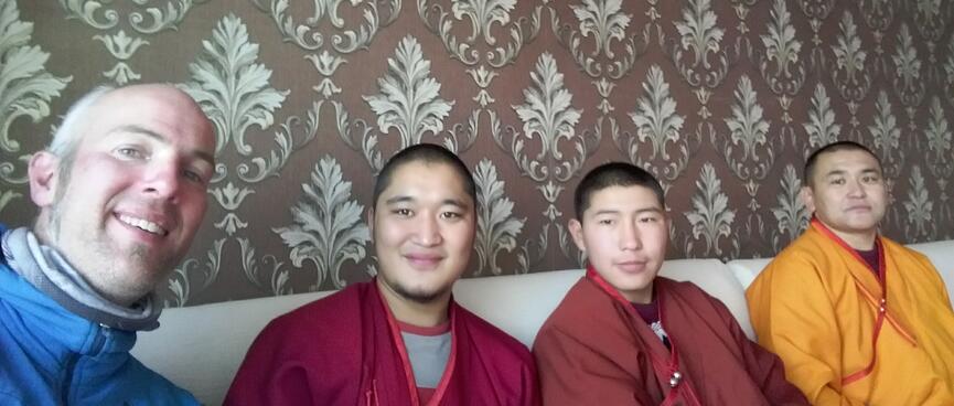 I sit with three monks in a cafe.