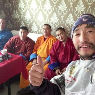 A selfie of two cyclists and the three monks.