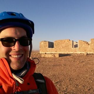 Smiling selfie with the roofless building.