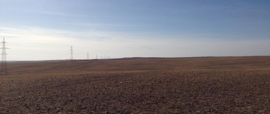 To my left, a line of tall power pylons extends as far as the eye can see.