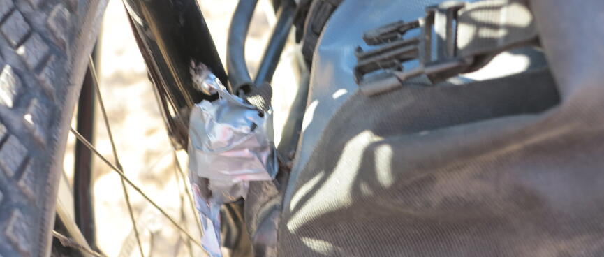 Silver duct tape wrapped around oine of the front pannier hooks.