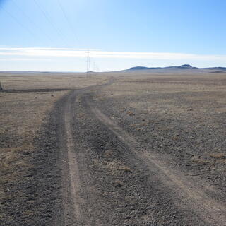 The gravel road turns to the right and then the left.