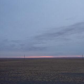 Grey sky with a sliver of pink at the horizon.