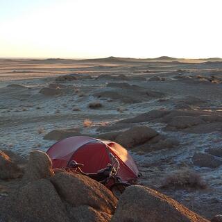 My tent is sits behind a pile of small boulders.