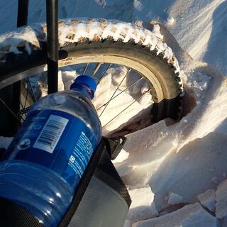 My bike's front wheel is half submerged in fresh powder.