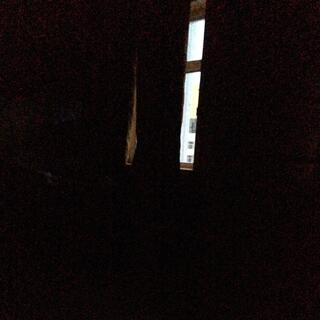 A thin strip of daylight is visible through the parted curtains.