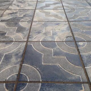 Squares and circles form ornate patterns on the footpath, in Chita.