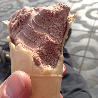 Cross section of a half eaten chocolate ice cream.