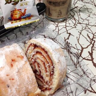 A jam roll and a cup of Chinese tea.