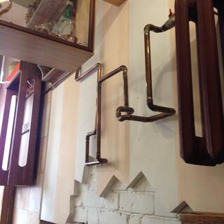 Curved bronze piping adorns the restaurant wall.
