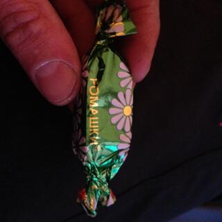A chocolate is wrapped in floral foil.