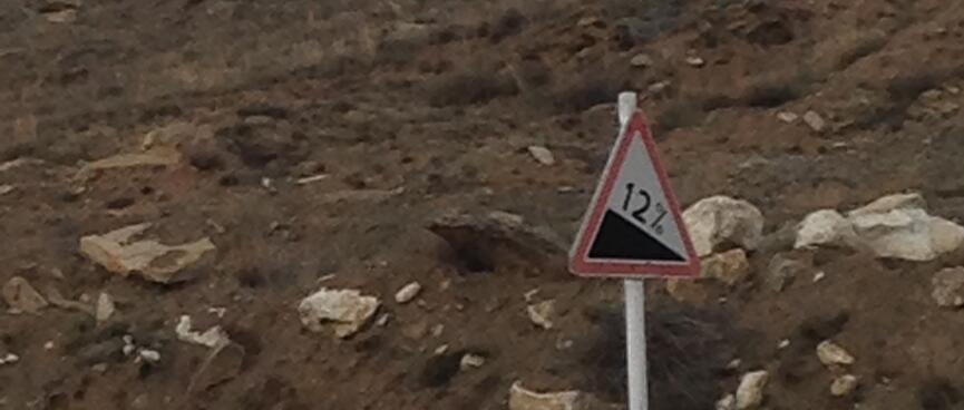 A road sign reads ʼ12%ʼ.