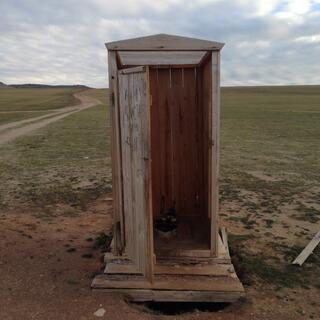 A wooden outhouse.