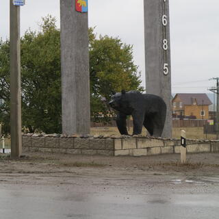 The Stella Khomutovo monument reads 'Khomutovo, 1685' and features a life size bear.