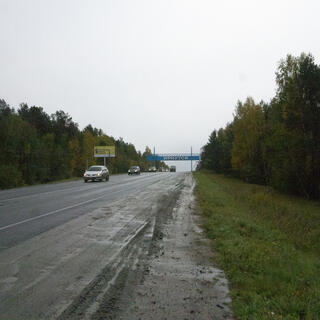 A blue Irkutsk sign straddles the highway at the city limits.