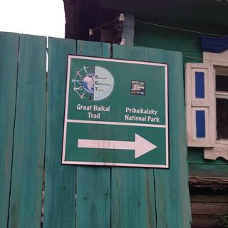 A sign points to Great Baikal Trail and Pribaikalsky National Park.
