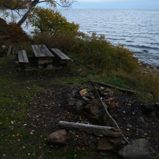 A used fire pit on the lake edge.