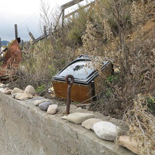 An old TV set is discarded on the side of the road.